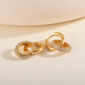 Macro shot of 18K gold plated hoop earrings with one polished and one pavé zircon ring