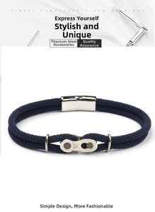 Detailed view of titanium steel mountain bike chain buckle on blue braided cord bracelet