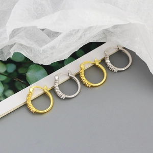 Detail showing 925 hallmark on silver and gold zircon hoop earrings for women