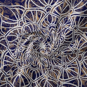 Detailed close-up of mandala tapestry fabric showing deep blue and gold geometric patterns