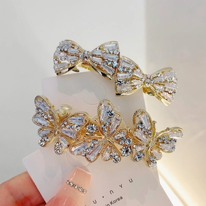 Elegant gold butterfly hair clip with crystal rhinestones on a display card for women