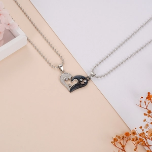 Detail of I Love You engraved heart pendants in silver and black with cubic zirconia