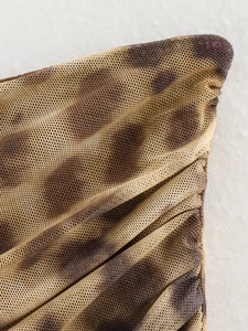 Detail of breathable leopard print mesh fabric showing delicate texture and soft drape