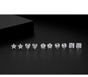 Detail of five-pair S999 silver stud earring set with zircon shapes on black background