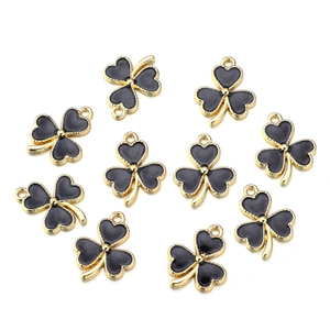 Macro view of 10 black and gold alloy shamrock charms for DIY jewelry making