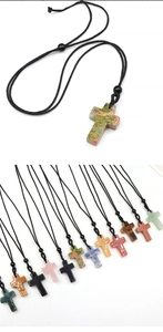 Macro detail of polished natural crystal cross pendants in various colors with woven cords