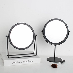 Minimalist round black metal desktop makeup mirror with a sleek Nordic style wire stand