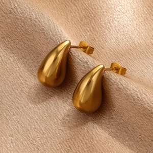 Polished 18K gold plated teardrop stud earrings on elegant champagne silk fabric