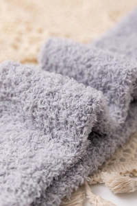 Detail shot of soft grey coral fleece fabric showing warm and fuzzy plush texture