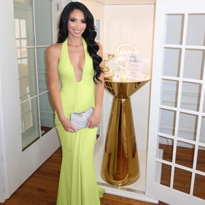 Detail of elegant backless halter neck mermaid dress in vibrant lime green satin
