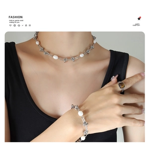 Detail of French style gold-plated titanium necklace and bracelet set with pearls