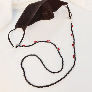 Beaded eyewear and mask chain featuring red cherry accents on a sleek black beaded string