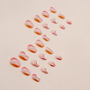 Short oval press-on nails with orange wavy art and gold glitter highlights