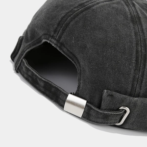 Detail of adjustable metal buckle and strap on a washed black denim Miki Hat for men