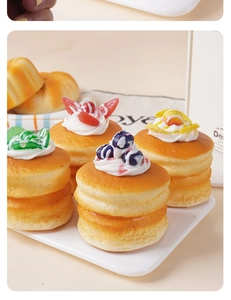 Detailed macro view of four artificial soufflé cakes with realistic fruit toppings and textures