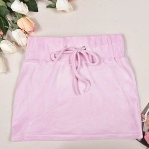 Detailed view of pink velvet mini skirt with adjustable drawstring waist and soft texture