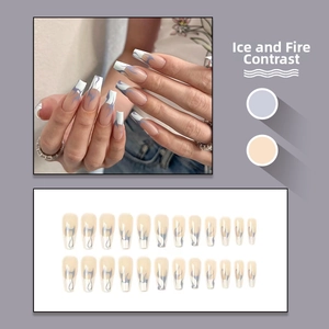 Detail view of long coffin press-on nails featuring blue flame patterns on a model hand
