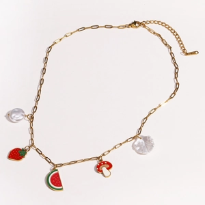 Detailed top view of gold chain necklace featuring strawberry, watermelon, and pearl charms
