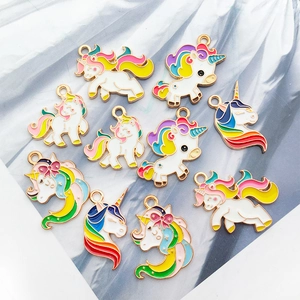Detailed view of colorful unicorn enamel charms with gold metal edges for jewelry making