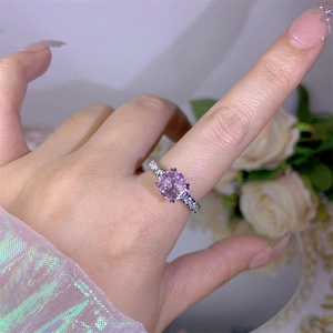 Close-up of square cut purple zircon ring with pavé side stones on silver band