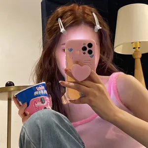 Pink heart pattern iPhone case with 3D heart-shaped socket stand in mirror selfie view