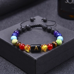 Adjustable seven chakra volcanic lava stone bracelet with golden letter A bead