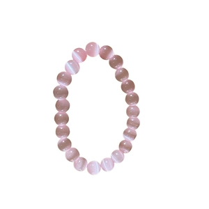 Elegant pink cat eye stone beaded bracelet with glossy round beads on white background