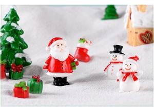 Miniature resin Santa and snowman figurines in a snowy Christmas micro landscape scene