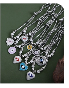 Detailed view of silver stainless steel evil eye charm bracelets with colorful enamel inlay