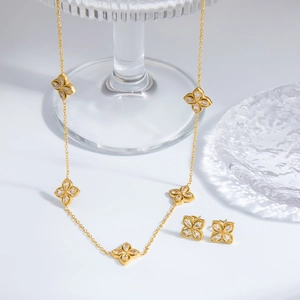 Golden stainless steel four-leaf flower necklace and earring set with crystals
