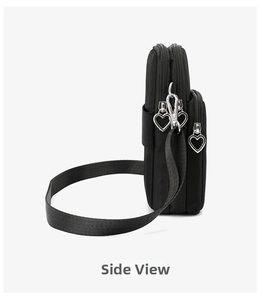 Side view showing three-layer zipper compartments and heart-shaped pulls on black mini bag