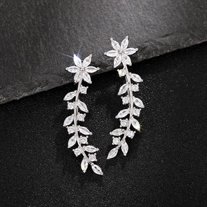 Macro view of silver floral drop earrings with marquise-cut zircons and vine detail