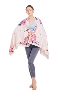 Detail showing soft microfiber beach towel with floral patterns on a pink background