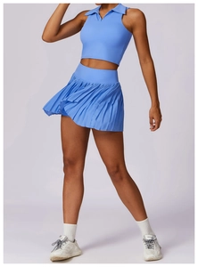 Detail of light blue athletic set featuring a polo collar tank top and pleated tennis skirt