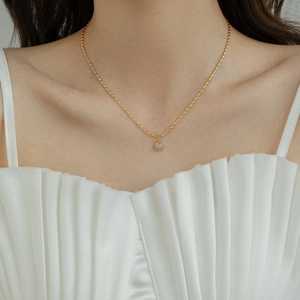 Elegant 18K gold plated necklace with a green aventurine bean pendant on model