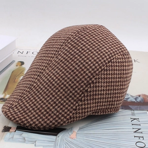 Close-up of brown houndstooth pattern fabric and texture on a retro newsboy cap
