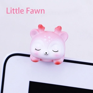 Close-up of pink mini deer resin ornament for monitor frame and car dashboard
