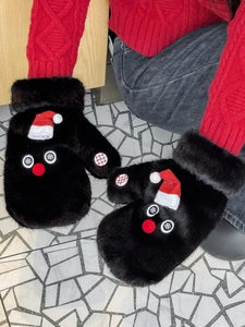 Detail of plush black mittens with snowman face and mini red Santa hat decoration