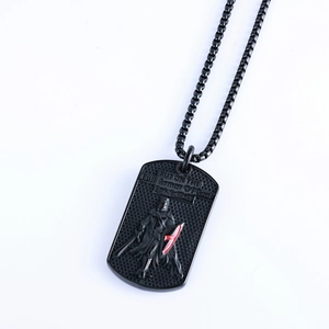 Detail of black dog tag necklace with embossed Full Armor of God Bible verse text