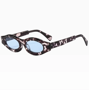 Detailed side view of tortoise shell sunglasses with light blue lenses and chunky frame