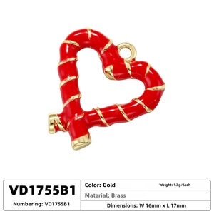 Detailed view of red enamel heart pendant with golden spiral texture on brass