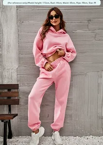 Detail of pink fleece hoodie and jogger set with ribbed cuffs and elastic waistband