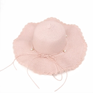 Pink straw sun hat with wavy brim, delicate pearl embellishments and ribbon tie for women