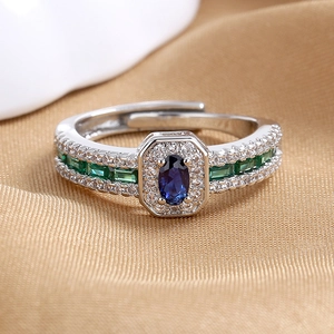 Vintage silver open ring featuring a blue oval gemstone and green zircon side stones