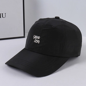 Detail shot of the solid color plush fleece baseball cap with white script embroidery