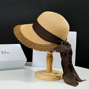 Women's wide brim straw sun hat with elegant brown chiffon bow ribbon for outdoor beach use