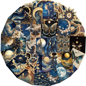 Close-up of golden celestial stickers with moon, butterfly, and floral motifs