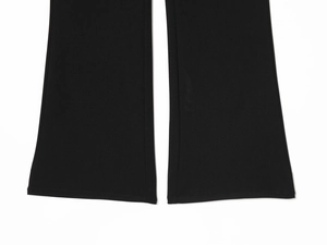 Detailed macro view of the black flared trousers hem with neat stitching and edging