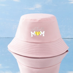 Pink Softball Mom bucket hat with embroidered heart on light blue wooden background