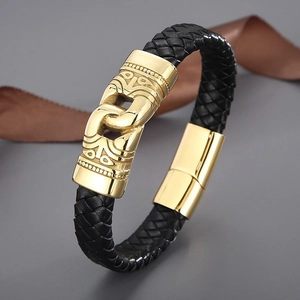 Macro view of black braided leather strap and engraved golden magnetic clasp detail